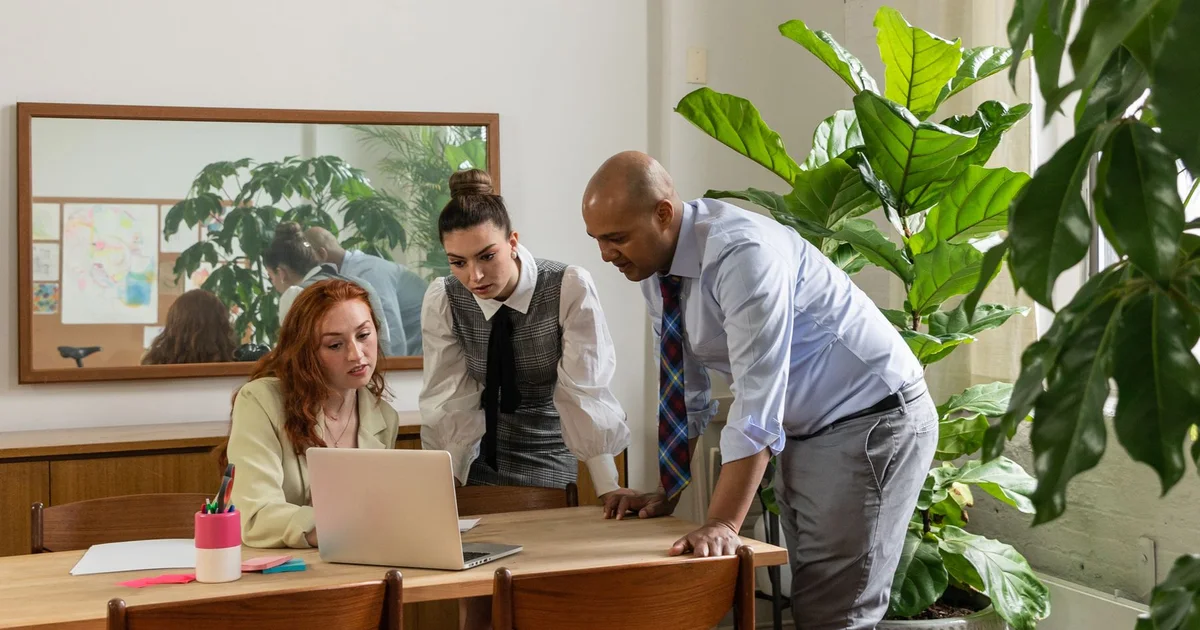 Three colleagues collaborating in a bright office.