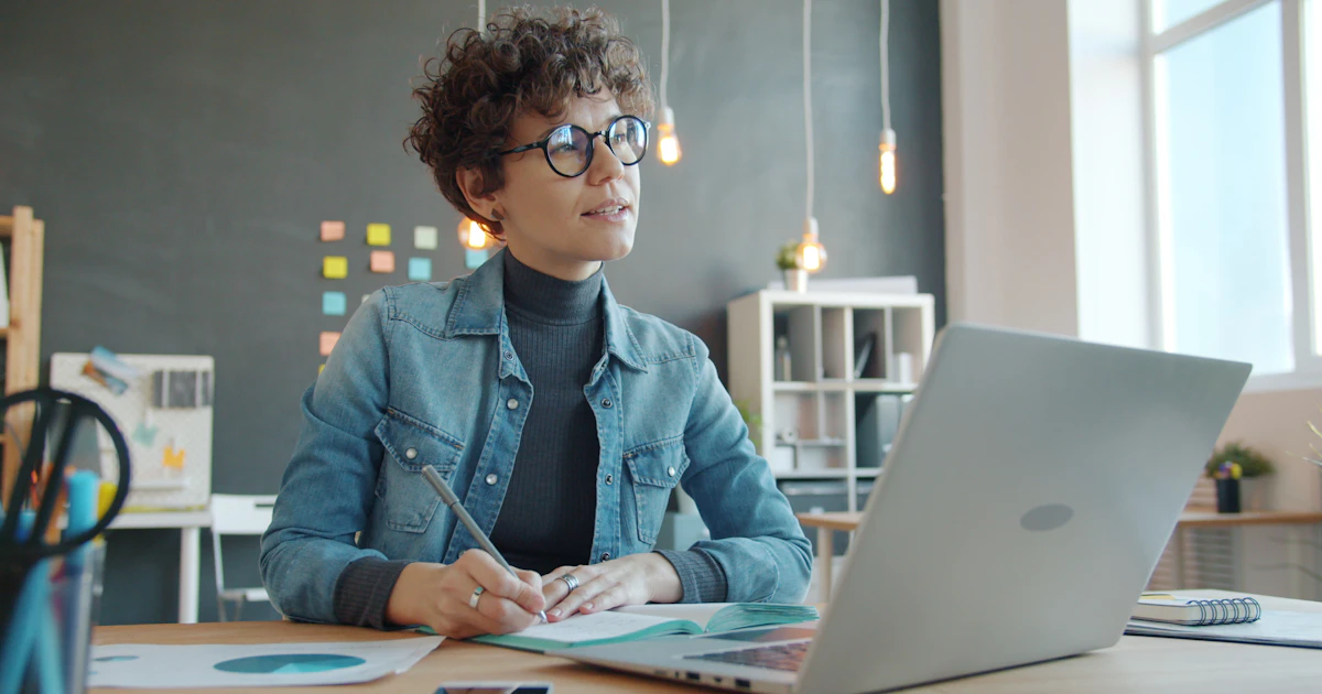 A founder planning work with a notebook and laptop.